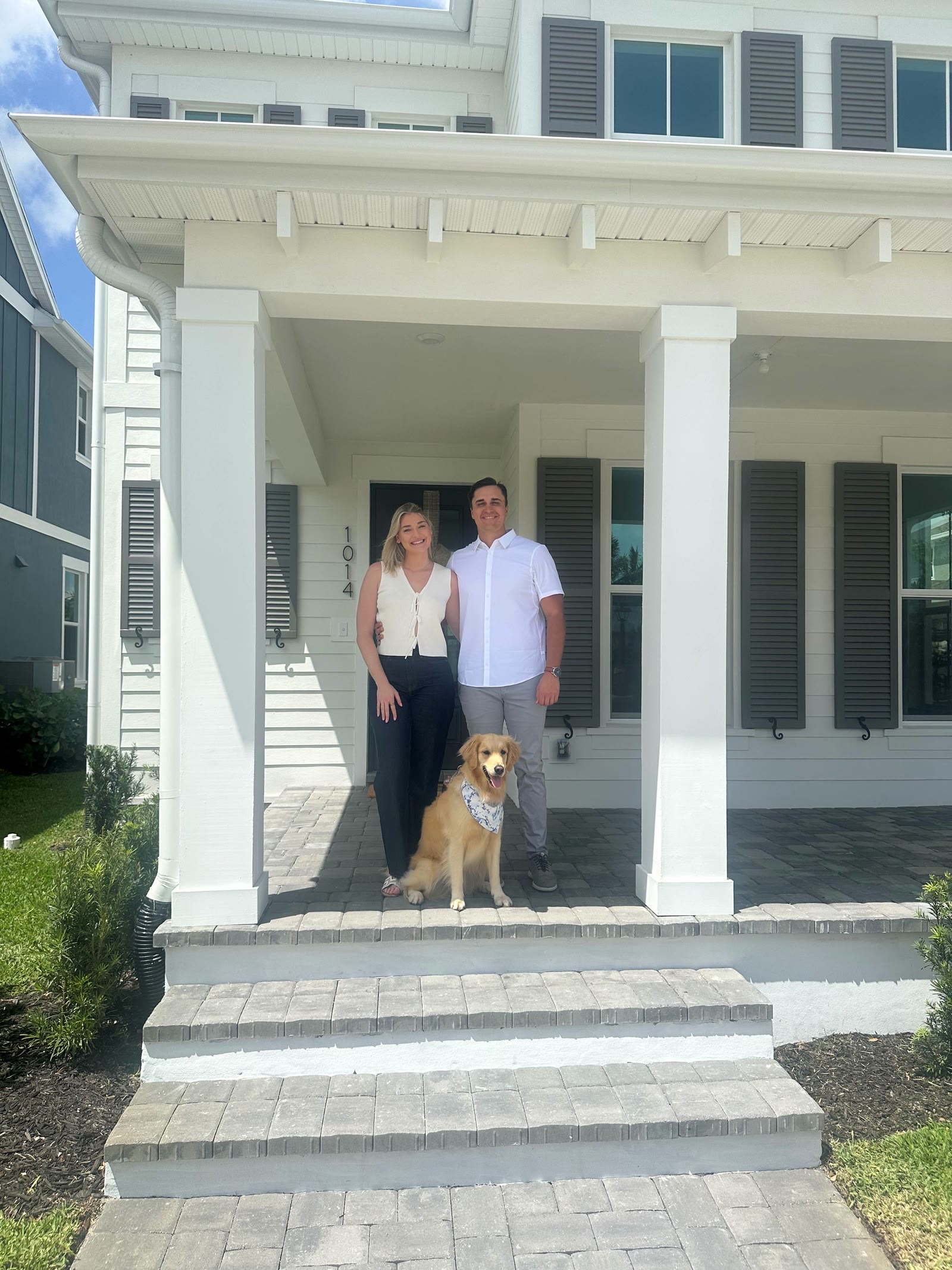 Rosette Park's first residents with their dog on their front porch